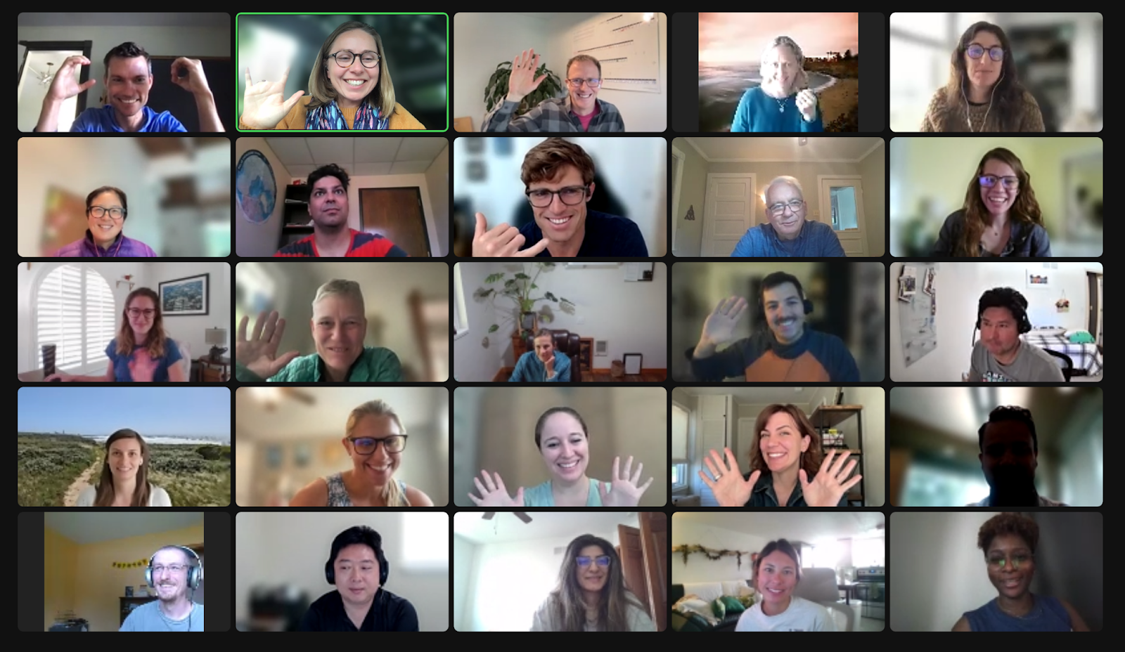 screenshot of smiling waving people in 5 x 5 grid view of a video conference